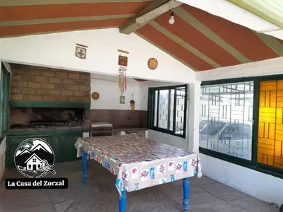 a room with a table and a stove in it at La Casa del Zorzal in San Antonio de Arredondo