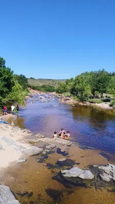 a group of people swimming in a river at La Casa del Zorzal in San Antonio de Arredondo