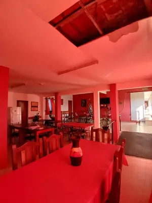 a room with tables and chairs with red lighting at Brisas del Norte in Villa Carlos Paz
