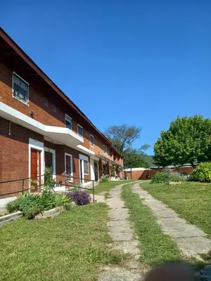 a brick building with a path in front of it at Brisas del Norte in Villa Carlos Paz