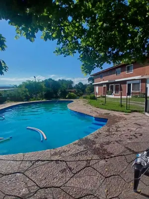 a pool of water in front of a building at Brisas del Norte in Villa Carlos Paz
