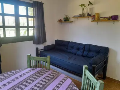 a living room with a blue couch and two chairs at Azul in Villa del Dique