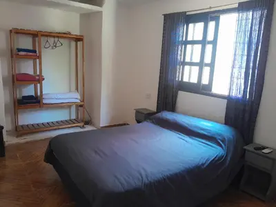 a bedroom with a blue bed and a window at Azul in Villa del Dique