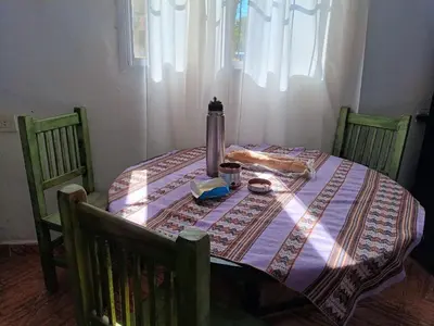 a table with a table cloth and a bottle on it at Azul in Villa del Dique
