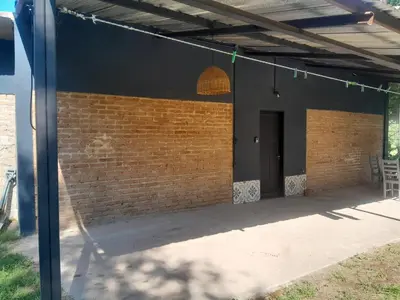 a patio with a brick wall and a black building at Azul in Villa del Dique