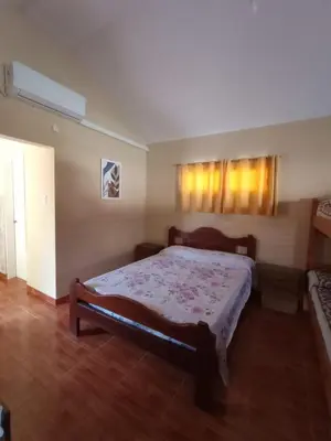 a bedroom with a large bed in a room at Departamentos Ecuador in Villa Carlos Paz