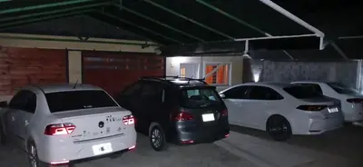 a group of three cars parked in a garage at Departamentos Ecuador in Villa Carlos Paz