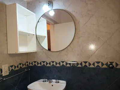 a bathroom with a sink and a mirror at Departamentos Ecuador in Villa Carlos Paz