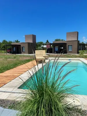 a house with a palm plant next to a swimming pool at Casasdecampo pasabaxaqui in Villa Anizacate