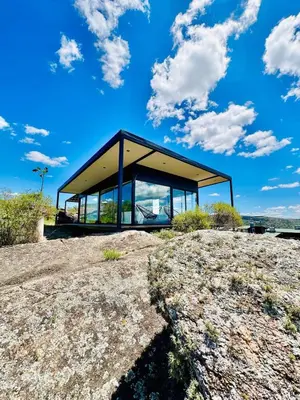 a glass house on top of a hill at Surrexit Suites in Tanti