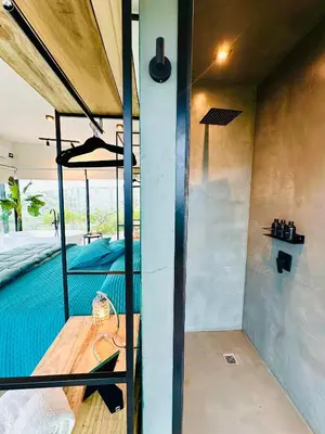 a room with a swimming pool in a house at Surrexit Suites in Tanti