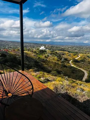 a umbrella sitting on top of a wooden deck at Surrexit Suites in Tanti