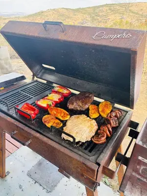 a grill with hamburgers and other food on it at Surrexit Suites in Tanti