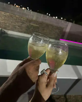 two people are holding up glasses of wine at Casa Francesca in Villa Carlos Paz