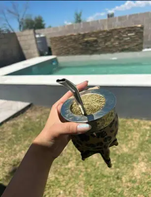 a hand holding a cup with a spoon in it at Casa Francesca in Villa Carlos Paz