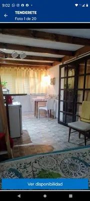 a view of a living room with a table and chairs at Tenderete in Villa General Belgrano