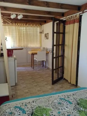 a room with a door open to a kitchen with a table at Tenderete in Villa General Belgrano