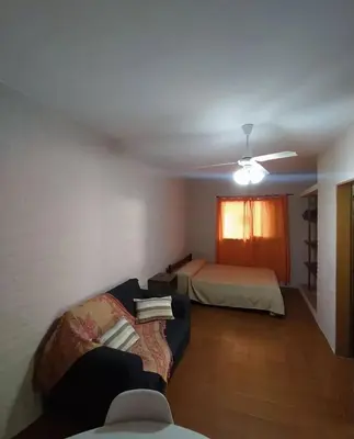 a living room with a couch and a bed at Residencial El aromo in Villa Cura Brochero