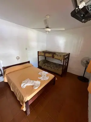 a bedroom with a bed with two towels on it at Residencial El aromo in Villa Cura Brochero