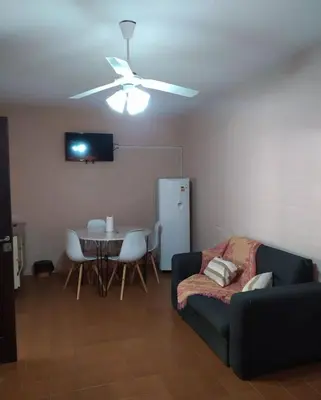 a living room with a couch and a table at Residencial El aromo in Villa Cura Brochero