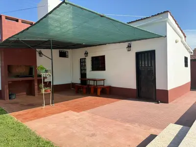 a building with a green canopy on a patio at Aires de familia in Villa Carlos Paz