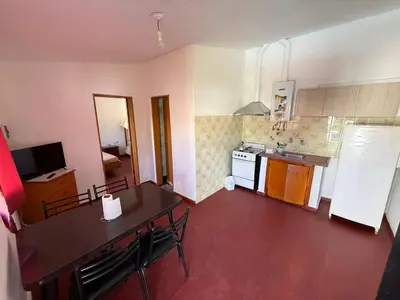 a kitchen with a table and chairs and a counter top at Aires de familia in Villa Carlos Paz