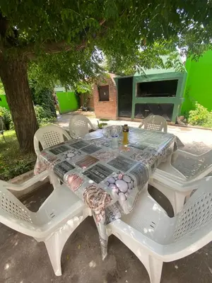 a table with chairs and a table cloth on it at Casa Familiar Centrica Abdulle in Villa Cura Brochero