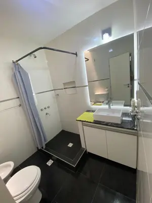 a bathroom with a toilet and a sink and a mirror at Casa Familiar Centrica Abdulle in Villa Cura Brochero