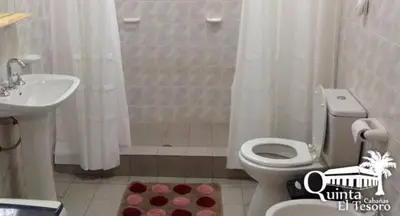a bathroom with a toilet and a sink and a shower at Cabañas Quinta El Tesoro in Villa Dolores