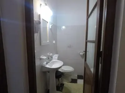 a small bathroom with a sink and a toilet at Cabañas Quinta El Tesoro in Villa Dolores