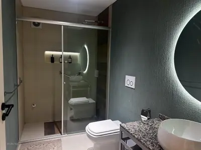 a bathroom with a toilet and a glass shower at Apart Lunge in Cordoba