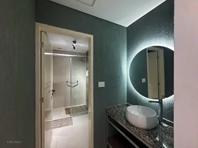 a bathroom with a sink and a shower with a mirror at Apart Lunge in Cordoba