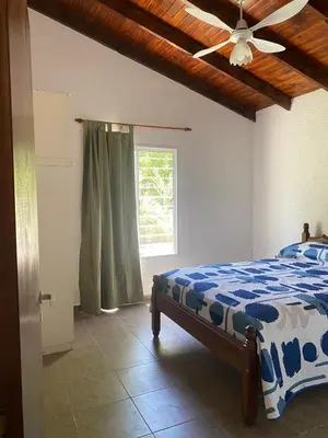 a bedroom with a bed and a ceiling fan at Casa Paz in Santa Rosa de Calamuchita