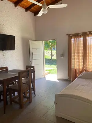 a bedroom with a dining room table and a bed at Casa Paz in Santa Rosa de Calamuchita