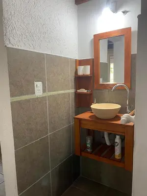 a bathroom with a sink and a mirror at Casa Paz in Santa Rosa de Calamuchita