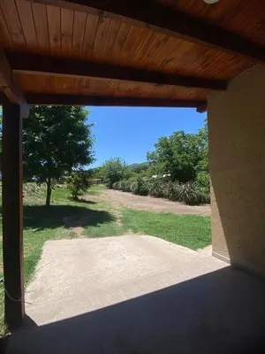 an open patio door with a view of a yard at Casa Paz in Santa Rosa de Calamuchita