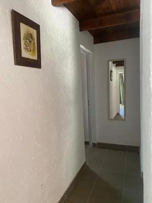 a hallway with white walls and a picture on the wall at Casa Paz in Santa Rosa de Calamuchita