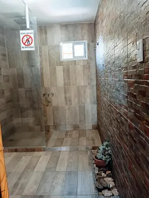 a bathroom with a shower and a sign that says no smoking at La Cautivadora, Potrero de Garay in Potrero de Garay