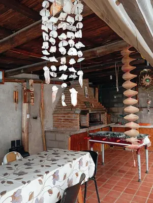 a dining room with a table and a chandelier at La Cautivadora, Potrero de Garay in Potrero de Garay
