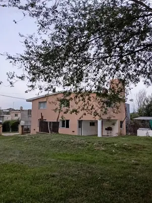 an old house in a yard with a tree at La Cautivadora, Potrero de Garay in Potrero de Garay