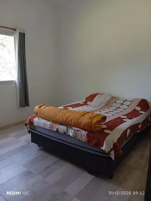 a bed with a blanket on top of it in a room at La Cautivadora, Potrero de Garay in Potrero de Garay