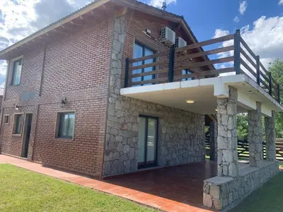 a brick house with a balcony on top of it at Casa Isolina in Arroyo de Los Patos