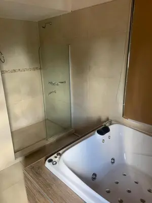 a white bath tub with a glass shower at Casa Isolina in Arroyo de Los Patos