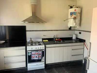 a kitchen with a stove and a sink at Casa Isolina in Arroyo de Los Patos
