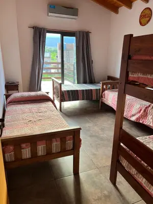 a room with three beds and a window with a view at Casa Isolina in Arroyo de Los Patos