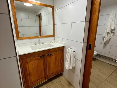 a bathroom with a sink and a mirror at Cabaña en villa de las Rosas in Villa de Las Rosas