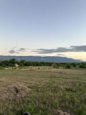 a field of grass with mountains in the background at Casa Isolina II in Arroyo de Los Patos