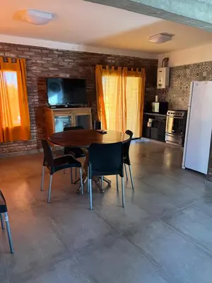 a dining room with a table and chairs in a kitchen at Casa Isolina II in Arroyo de Los Patos