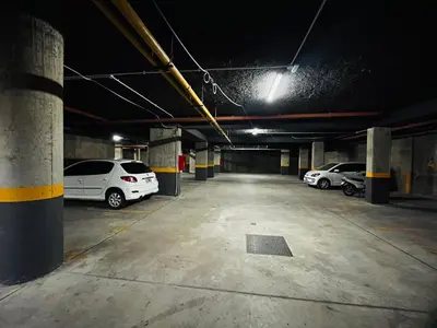 a parking garage with three cars parked in it at Veneto VIII in Villa Carlos Paz