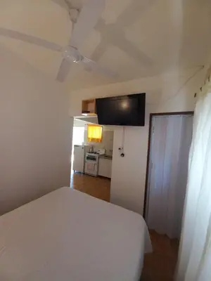 a bedroom with a bed and a flat screen tv on the ceiling at El Nogal Mina Clavero in Mina Clavero